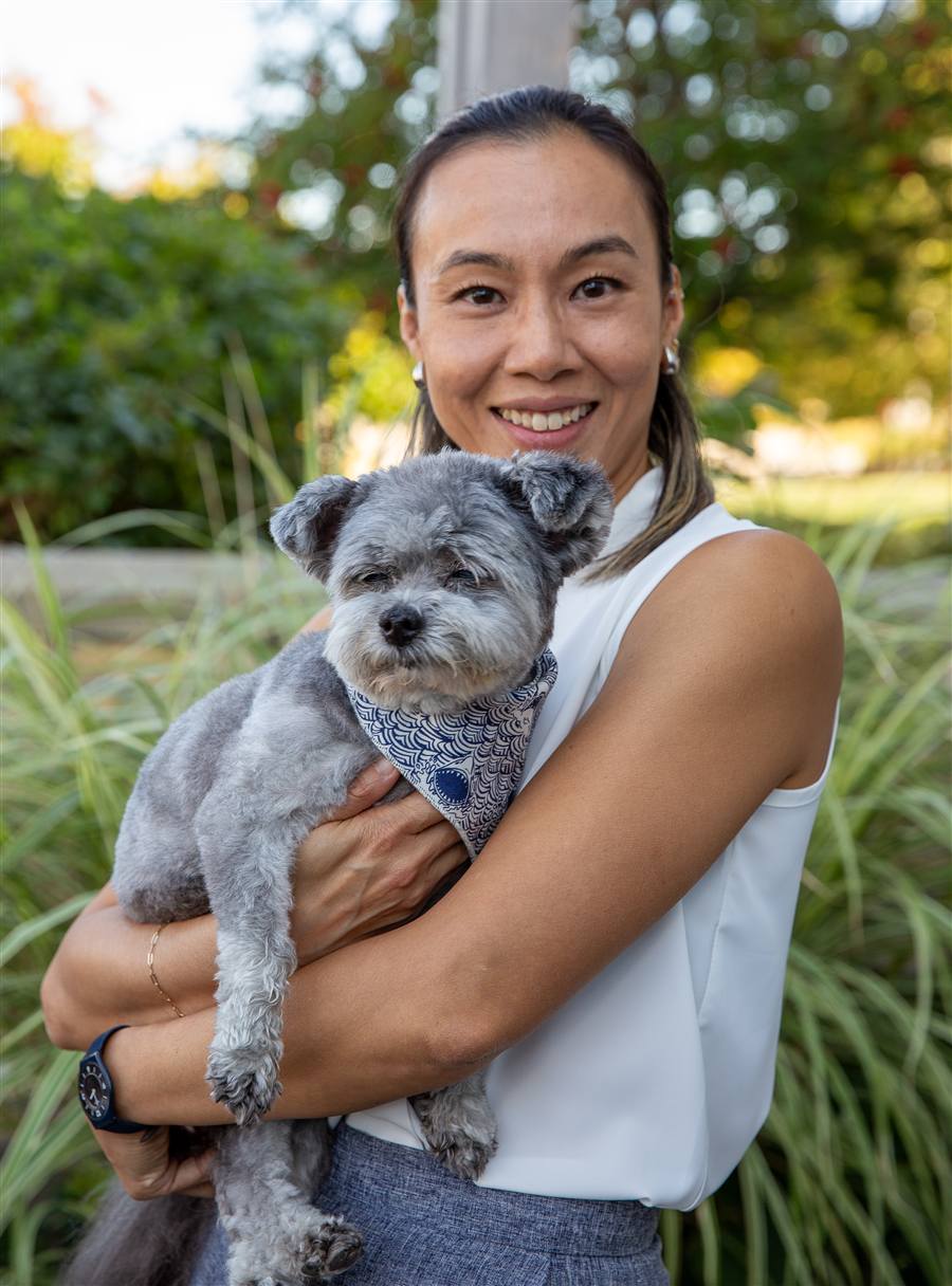 Dr. Jody Chiu holding the office dog outside the practice