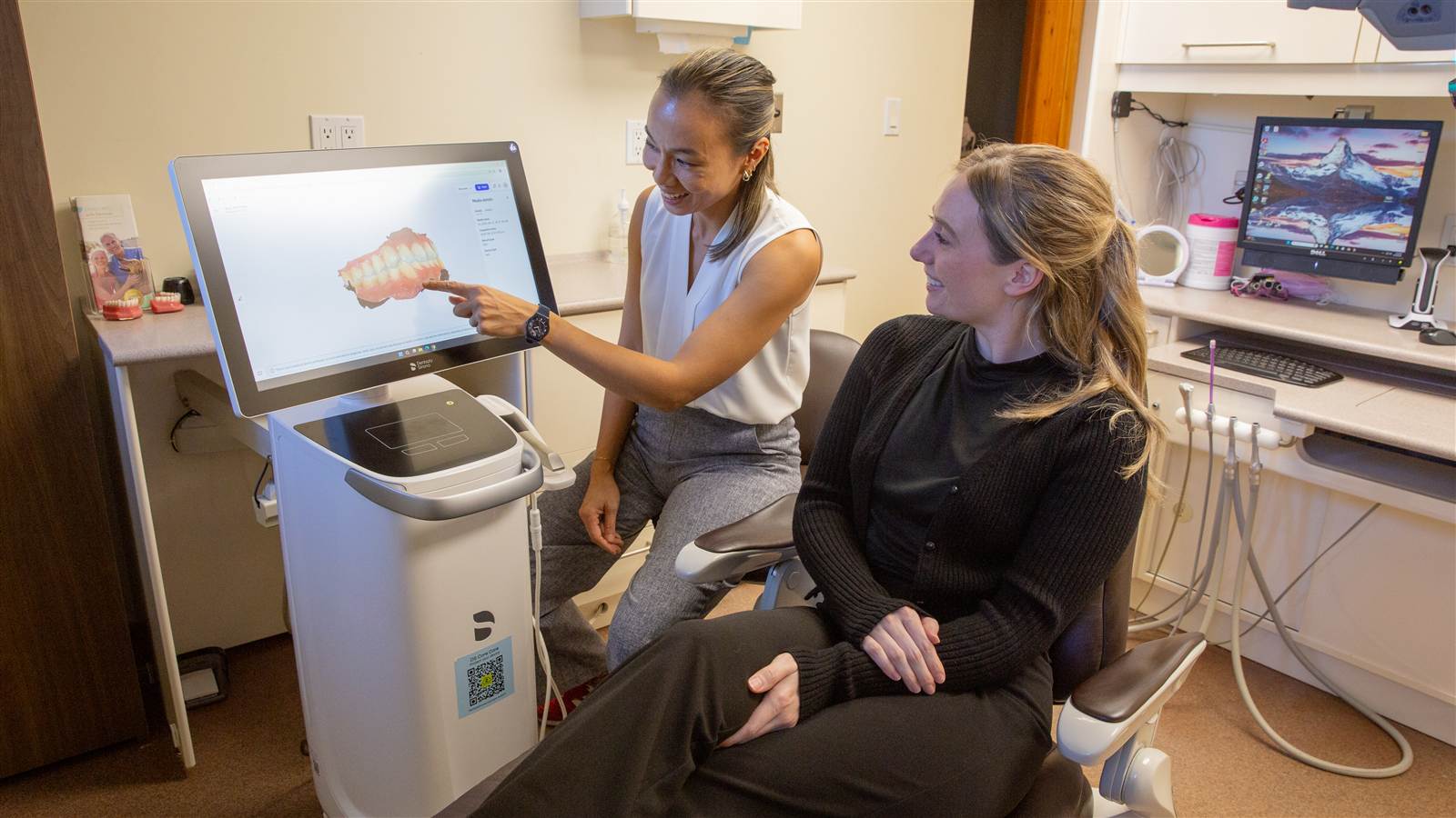 Dr. Jody Chiu showing a patient a 3D scan of their teeth
